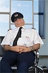 Pilot resting on a bench at an airport