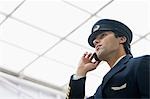 Pilot talking on a mobile phone at an airport