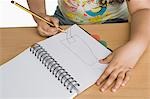 Mid section view of a girl drawing a picture