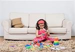 Girl playing with toys in a living room