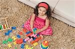 Girl playing with toys in a living room