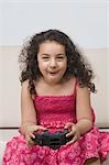 Girl playing a video game and making a funny face