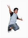 Boy jumping in air with his arm outstretched
