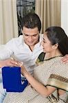 Man putting bangles on a woman's hand