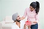 Woman giving a present to her husband