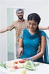 Woman chopping vegetables in the kitchen