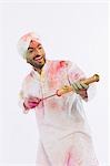 Man playing Holi with a pichkari