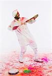 Man playing Holi with a pichkari