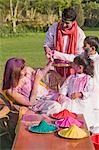 Family celebrating Holi with colors