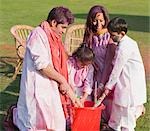 Family celebrating Holi with pichkaris