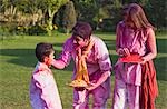 Family celebrating Holi with colors