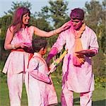 Family celebrating Holi with colors