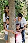 Couple playing with their children in a park