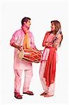 Couple celebrating Holi with musical instruments
