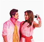 Couple taking a picture of themselves with a camera on Holi