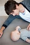 Man with baby on sofa