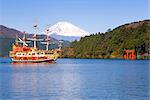 Tourist pleasure boat on lake Ashino-ko with the red torii gates of Hakone-jinja rising from the lake and snow capped Mount Fuji beyond, Fuji-Hakone-Izu National Park, Hakone, Central Honshu (Chubu), Japan, Asia