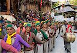 Group of women in full traditional clothes performing traditional dancing in a row with man beating on drum during Ataro religious festival in Baring Narj temple, Sangla, Baspa Valley, Kinnaur, Himachal Pradesh, India, Asia