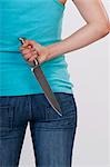 Woman Holding a Knife Behind Her Back