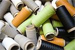 Recyclable composite textile fabrication department of factory, reels of excess coated thread