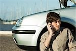 Man having car trouble, making phone call with cell phone