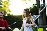 Children having fun under falling confetti