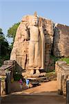 Giant statue dating from the 5th century, of the standing Buddha giving a blessing with his right hand, and lifting the robe to signify reincarnation with his left hand, Aukana, Sri Lanka, Asia