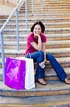 Woman Sitting on Steps with Shopping Bags