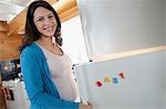 Pregnant woman by refrigerator