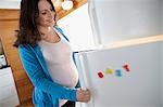 Pregnant woman by refrigerator