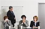 Businessman blowing nose in office