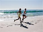 Young couple jogging on beach