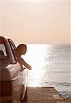 Woman with oldtimer by sea