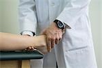 Doctor examining patient's feet and ankle