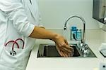 Healthcare worker washing hands in doctor's office