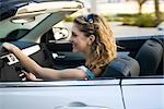 Young woman driving convertible