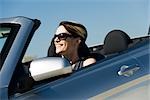 Woman driving convertible