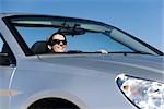 Woman enjoying pleasure drive on sunny day