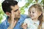 Father showing daughter his hand