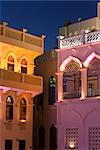 Colourfully illuminated latticed houses along the corniche, Mutrah, Muscat, Oman, Middle East