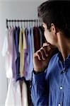 side view of young man looking at shirts