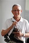 mature man with white hair holding roller blades