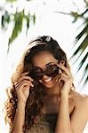 young woman looking out from sunglasses