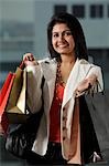 woman holding shopping bags and smiling