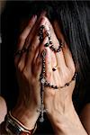 Woman praying with rosary, Chatillon-sur-Chalaronne, Ain, France, Europe