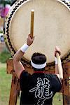 Drummer performing on a Japanese taiko drum at a festival in Kanagawa, Japan, Asia