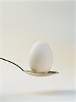 A white egg on a spoon