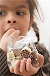 Girl eating chocolates out of a bag