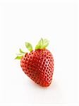 One strawberry on white wooden surface