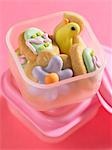 Decorated Easter biscuits in plastic food storage box